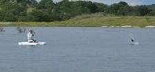 A bass jumps as John trys to reel it in.