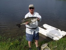 John with monster largemouth bass caught on a fly rod at Stillwaters Ranch.